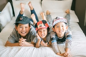 Three kids wearing Disney hats and ready for a trip to Disneyland, a photo by Amy Huang Photography